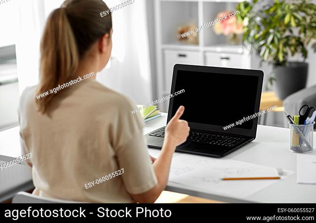 student woman with laptop and drawing at home