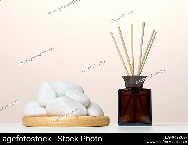 Brown glass bottle and wooden sticks, home fragrance