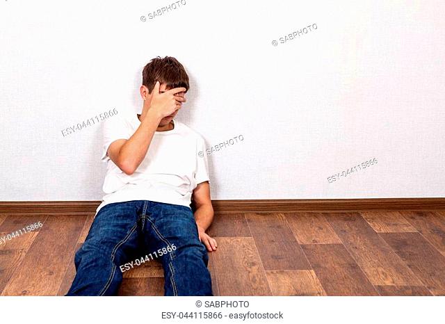 Sad Young Man on the Floor in the Room