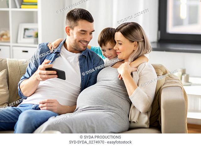 happy family with smartphone at home