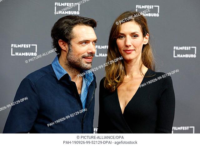 26 September 2019, Hamburg: French actors Doria Tillier (r) and Nicolas Bedos walk the red carpet at the opening of the Hamburg Film Festival