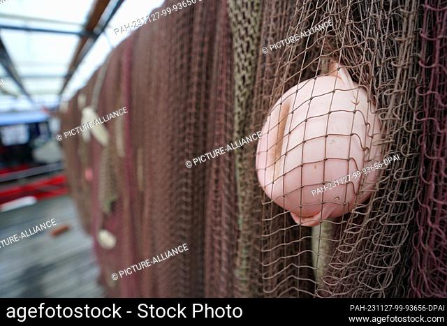 27 November 2023, Schleswig-Holstein, Lübeck: Nets hang from a jetty in the small fishing village of Gothmund on the River Trave