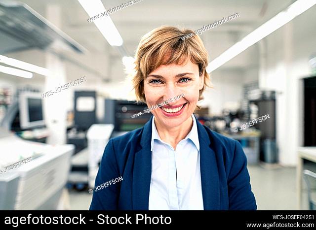 Mature businesswoman wearing casual smiling in workshop