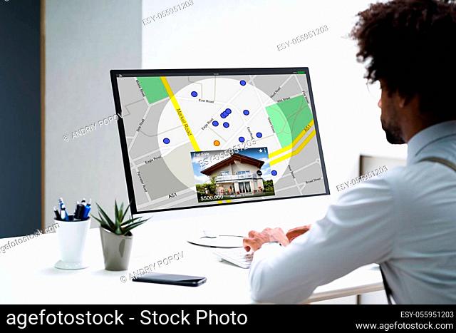 African American Searching Real Estate House On Map