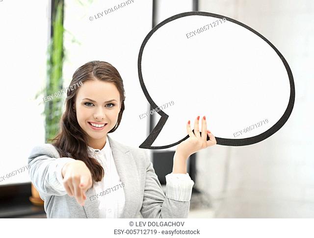 smiling businesswoman with blank text bubble pointing at you