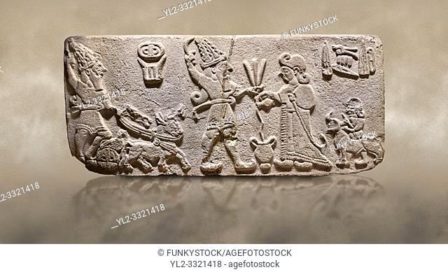 Aslantepe Hittite Orthostat. Limestone, Aslantepe, Malatya, 1200-700 B. C. . . Scene of offering drink and sacrifice. The god, with a symbol of divinity above