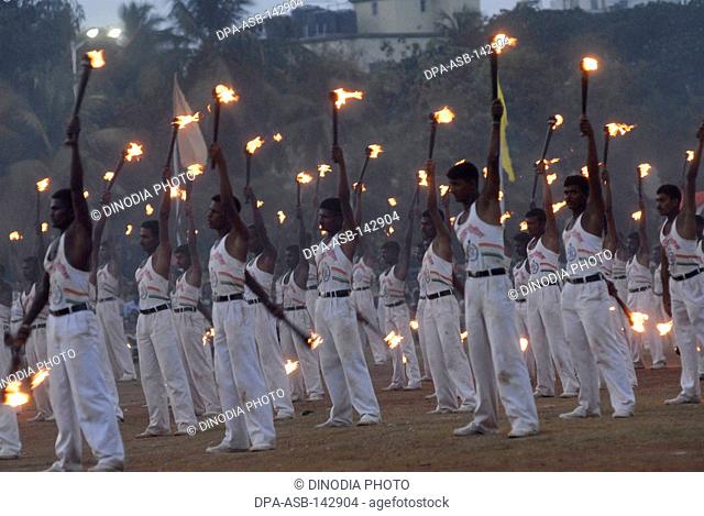 Dancers perform with torches during the annual Mumbai Police Tattoo show at Bombay now Mumbai ; Maharashtra ; India