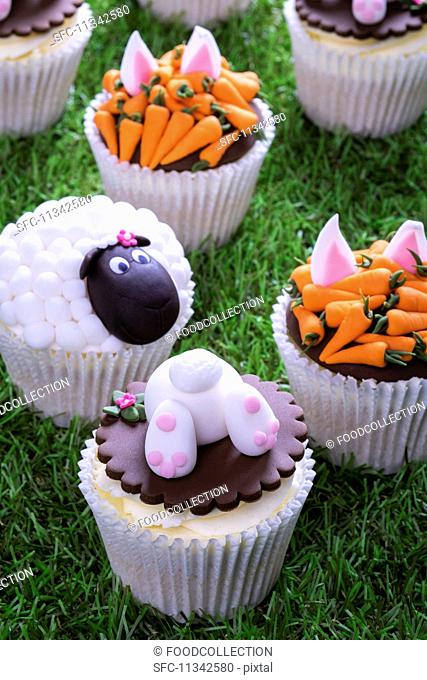 Various Easter cupcakes on a grass surface