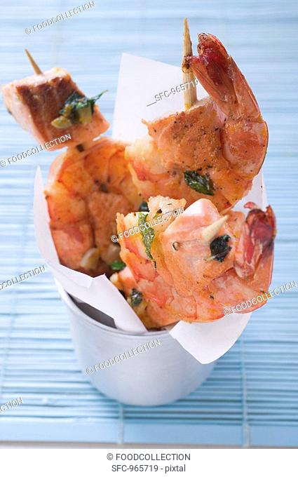 Salmon and prawn skewers with mint in a beaker