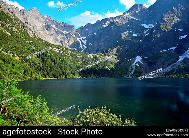 Lake Morskie oko, also called Eye of the Sea, surrounded by forest and mountains. High Tatras, Poland