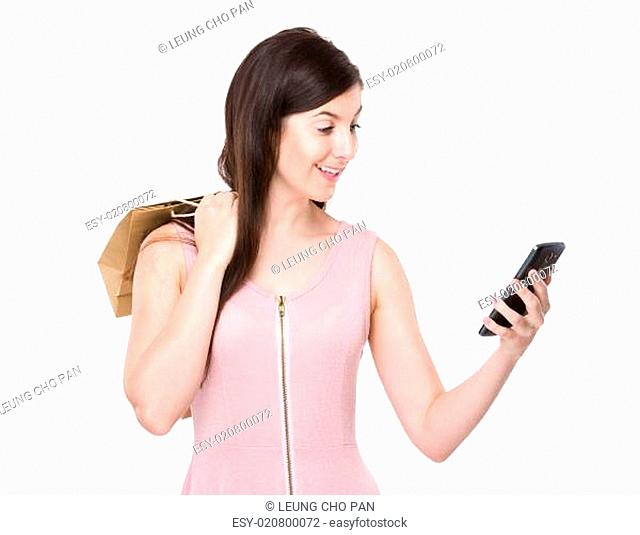 Woman hold with shopping bag and look at mobile phone