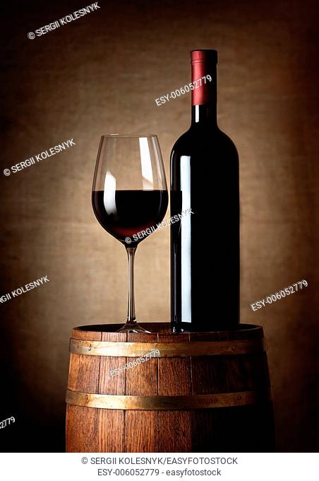 Wine standing on a barrel on a background of a canvas