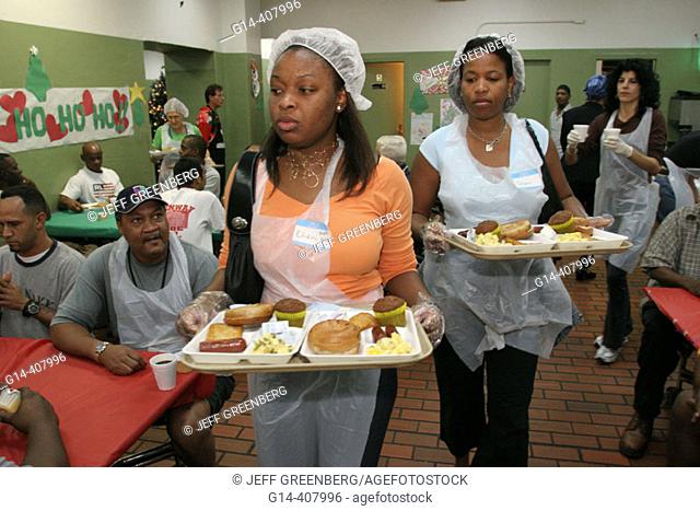 Volunteer servers. Christmas dinner for homeless, Camillus House, Miami, Florida. USA