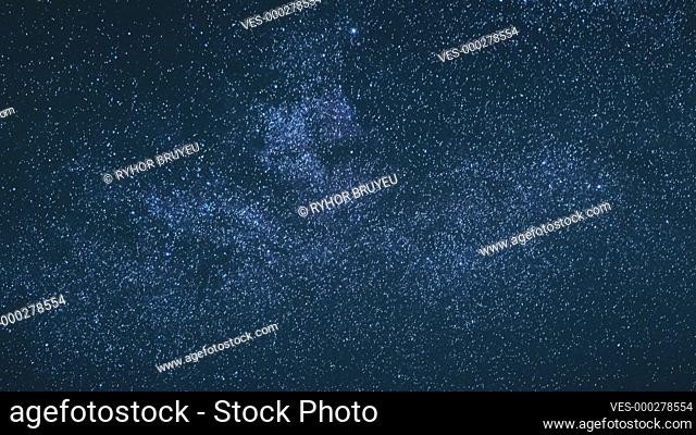 Blue Night Starry Sky With Glowing Stars. Bright Glow Of Sky Stars And Milky Way Galaxy. 4K. Natural Background Backdrop