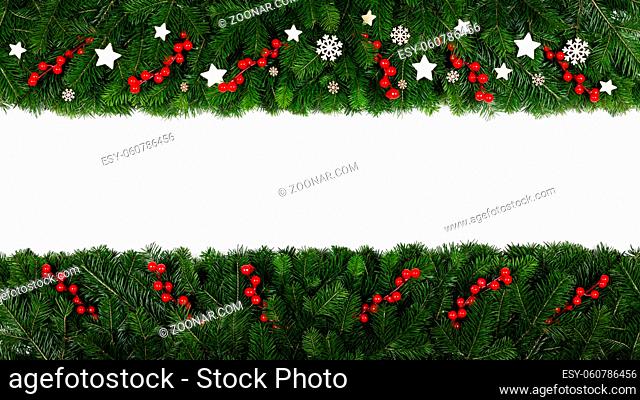 Christmas Border frame of tree branches on white background with copy space isolated, red and white decor of berries stars and snowflakes