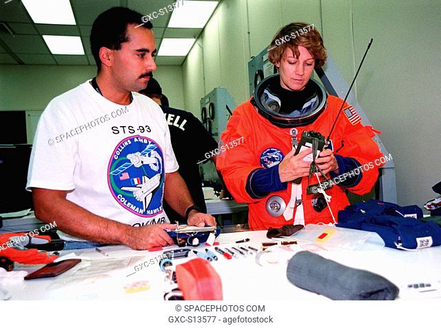 06/22/1999 --- In the Operations and Checkout Bldg., STS-93 Commander Eileen M. Collins checks out a PRC-112 survival radio, part of flight equipment