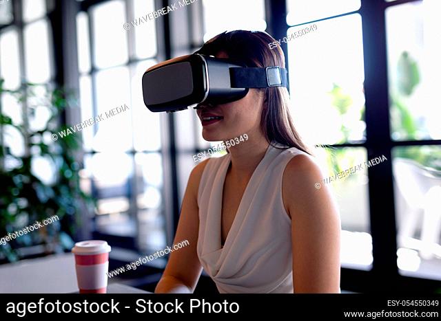 Asian woman using virtual reality at work