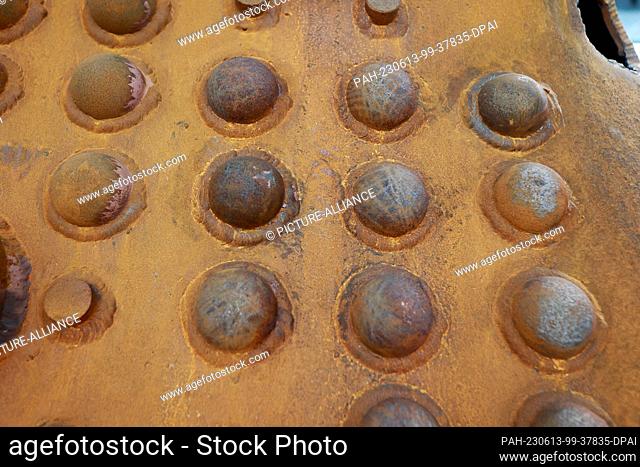 13 June 2023, Saxony-Anhalt, Wernigerode: Rivets can be seen on the long boiler of a steam locomotive in the new workshop of the Harzer Schmalspurbahnen HSB in...