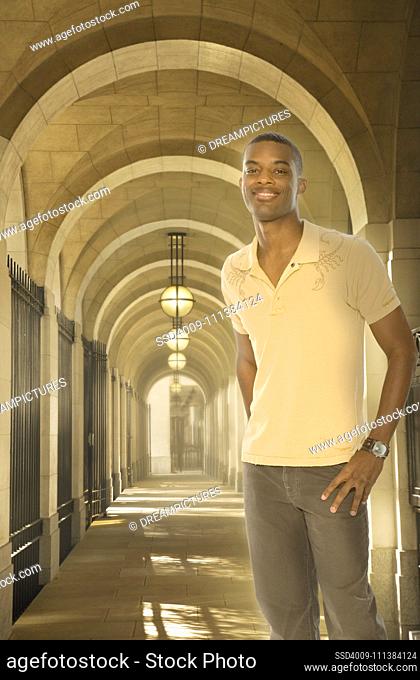 Black man standing in arched walkway