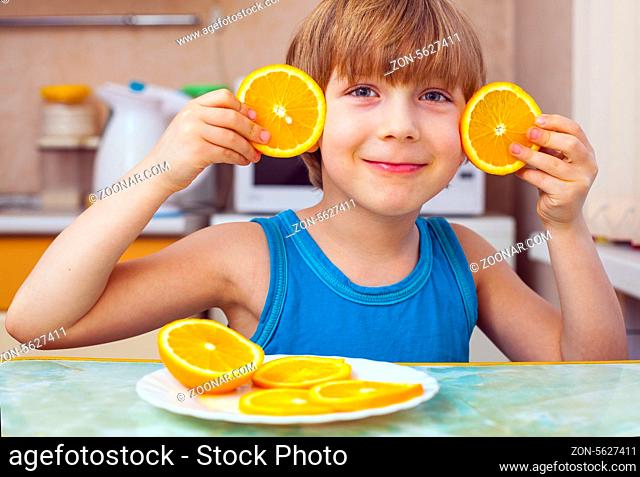 boy, breakfast, eats orange