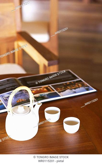 teapot and book on the wooden table