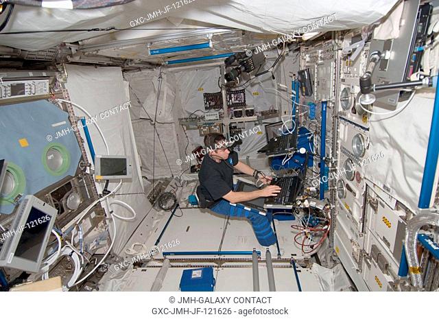 NASA astronaut Greg Chamitoff, Expedition 17 flight engineer, works with an experiment in the Columbus laboratory of the International Space Station
