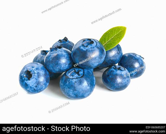 Blueberries isolated on white background. Extreme close up view of heap blueberry berries with green leaf. Isolated on white with clipping path