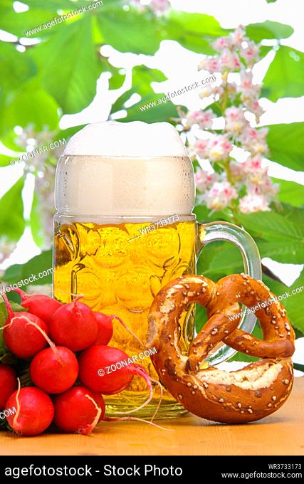big glass filled with Bavarian lager beer and snack for beer garden