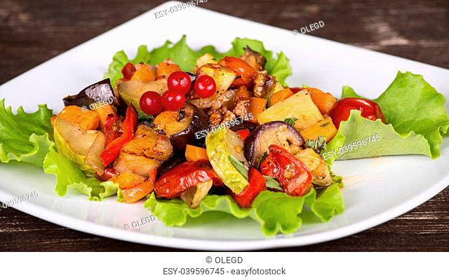 Roasted vegetables on a white plate, close up