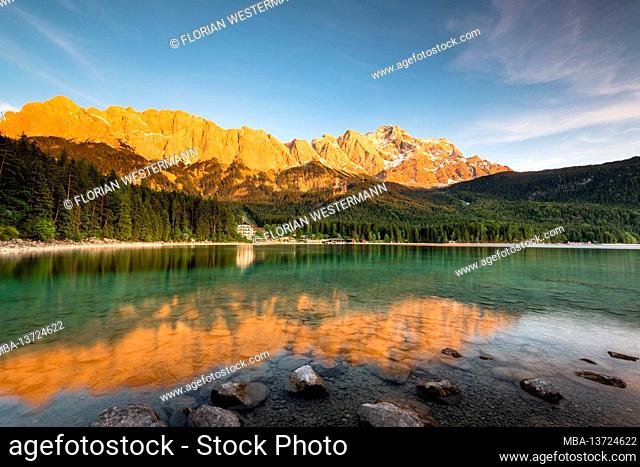 The view in the evening over the Eibsee with the Zugspitze, which is reflected in the water