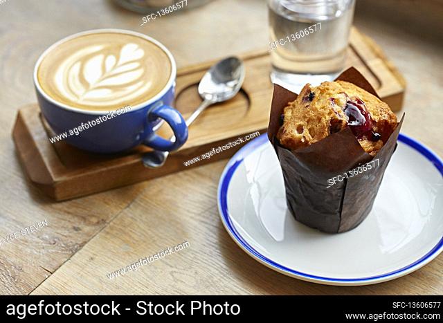 Blueberry muffin served with a coffee