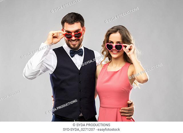 happy couple in heart-shaped sunglasses