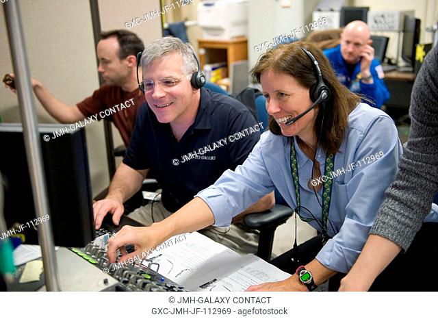 NASA astronauts Gregory H. Johnson, STS-134 pilot; and Shannon Walker, Expedition 2425 flight engineer, use the virtual reality lab in the Space Vehicle Mock-up...