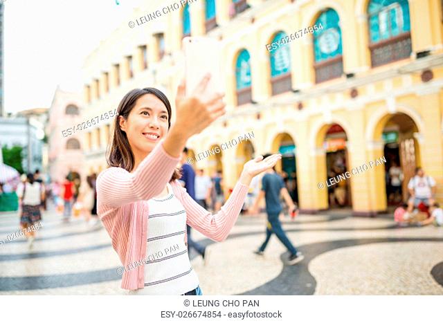 Woman take selfie in Macao city