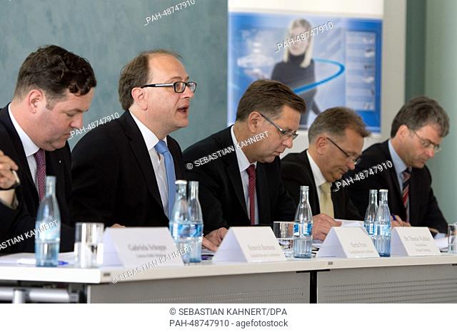 Manager directors of car-parts manufacturer Eberspraecher, Heinrich Baumann (L-R) and Martin Peters, as well as manager of exhaust techonology Thomas Waldhier
