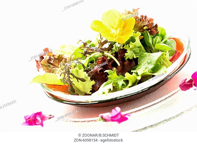 Leaf salad with yellow edible flower