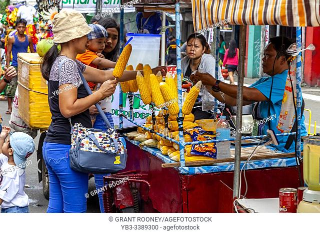 Filipino Women Buying and Selling Sweetcorn During The Dinagyang Festival, Iloilo City, Panay Island, The Philippines