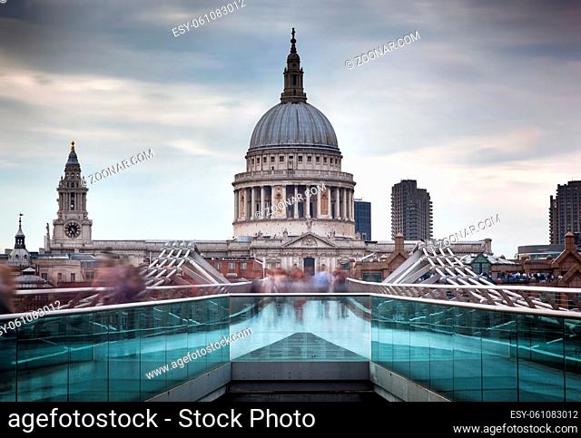 St Paul#39;s Cathedral dome seen from Millenium Bridge in London, the UK. Cloudy sky