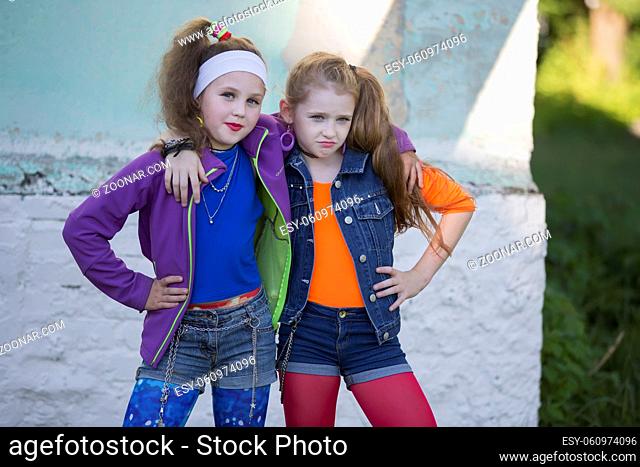 Two are funny little girls with bright makeup dressed in the style of the nineties