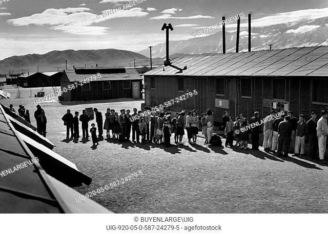 People of all ages wait in a line in front of a building at midday. Ansel Easton Adams 1902 – 1984 was an American photographer