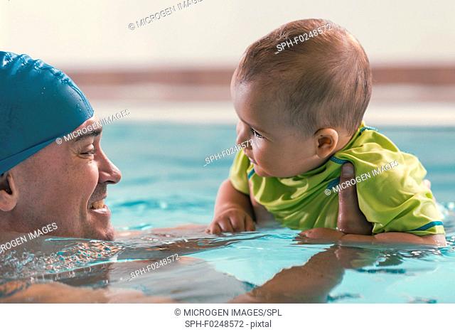 Father with baby boy in swimming pool