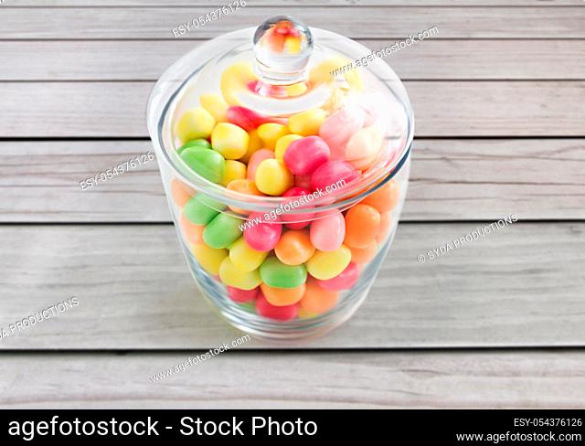 close up of glass jar with colorful candy drops
