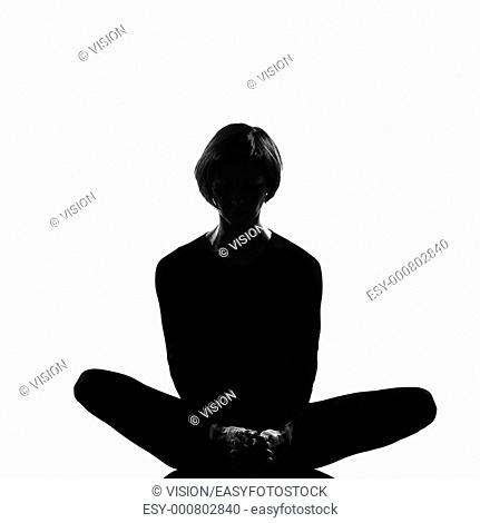 woman exercising sit lotus posture yoga in shadow grayscale silhouette full length in studio isolated white background