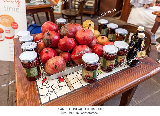 Pomegranate fruits and kind of jam on table outdoors for sale. Bodrum, Turkey