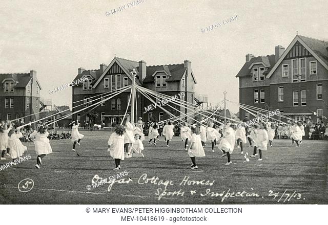 Children dance around maypoles during the 1913 sports and inspection day at the Hackney Union cottage homes at Ongar, Essex