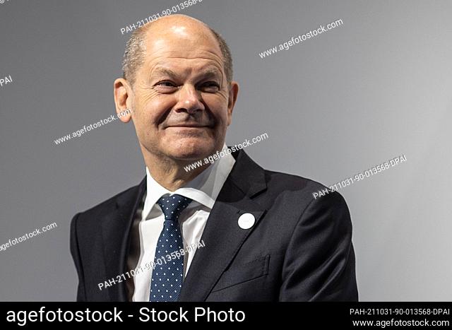 31 October 2021, Italy, Rome: German Finance Minister Olaf Scholz and German Chancellor Angela Merkel (not pictured) attend the closing press conference of the...