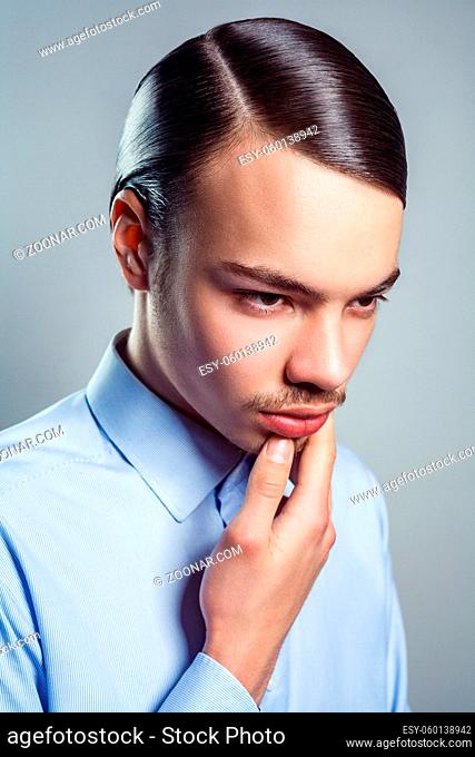 Portrait of young man with retro classic hairstyle. studio shot