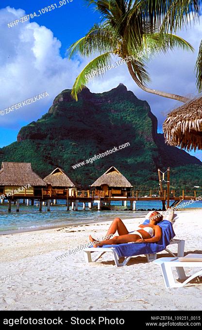 Picture shows a sunbather on a Bora Bora Lagoon beach.  Date: 24/02/2005  Ref: ZB784-109251-0015  COMPULSORY CREDIT: Oceans Image/Photoshot