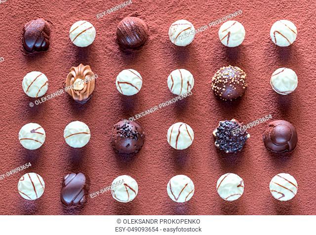 Chocolate candies on cocoa background
