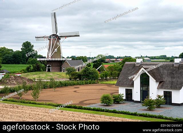 Dodewaard, Gelderland, The Netherlands - 07 12 2022 - Landscape view over farmland and an old windmill